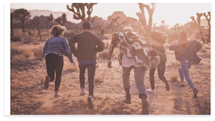 A group of five people running forward in the nature